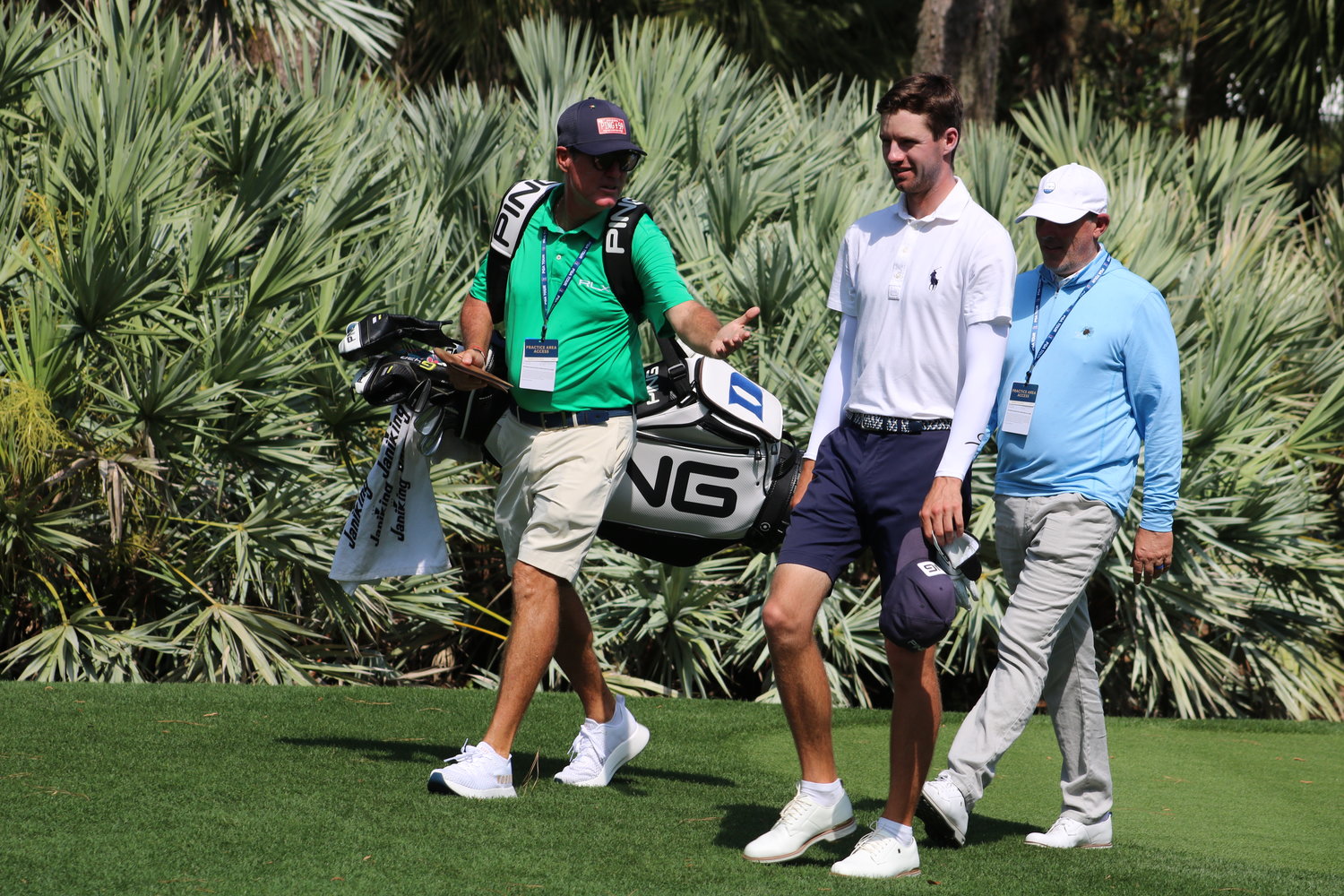 Players spend time analyzing their game with the caddy and swing coach during practice rounds.